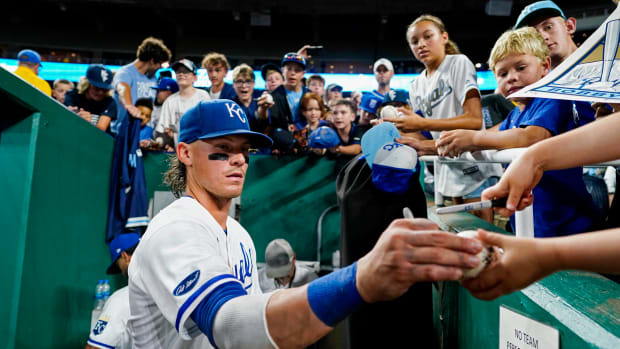 Jul 11, 2022; Kansas City, Missouri, USA; Kansas City Royals shortstop Bobby Witt Jr. (7) signs autographs after defeating the Detroit Tigers at Kauffman Stadium. Mandatory Credit: Jay Biggerstaff-USA TODAY Sports
